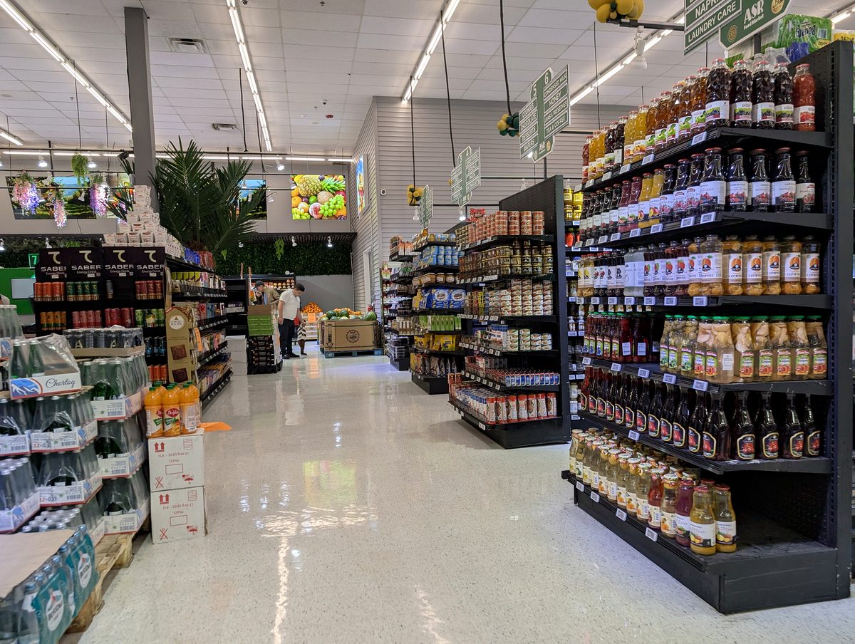 Shelves of imported jars, sauces and drinks down an ASR Food Market aisle.