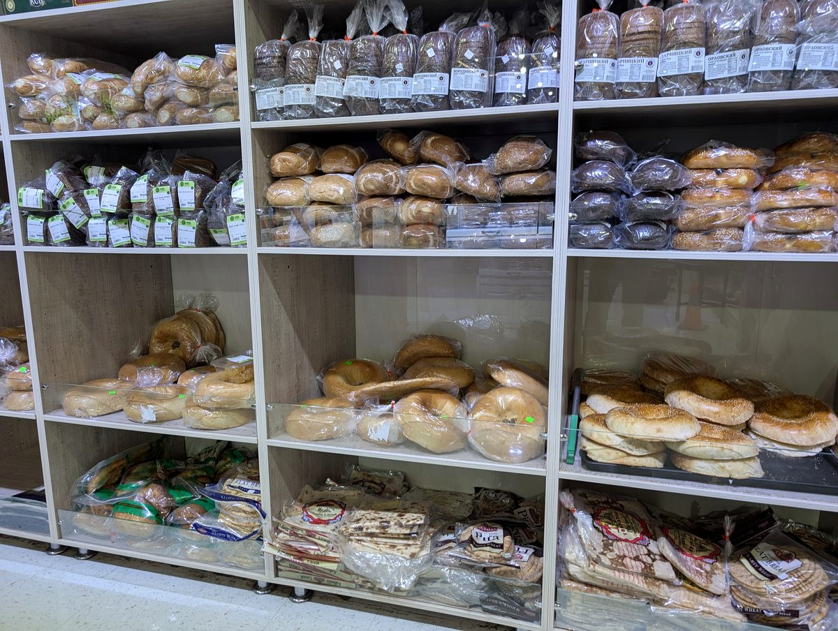 Shelves of bagged breads, bagels and rolls in the ASR Food Market bakery.