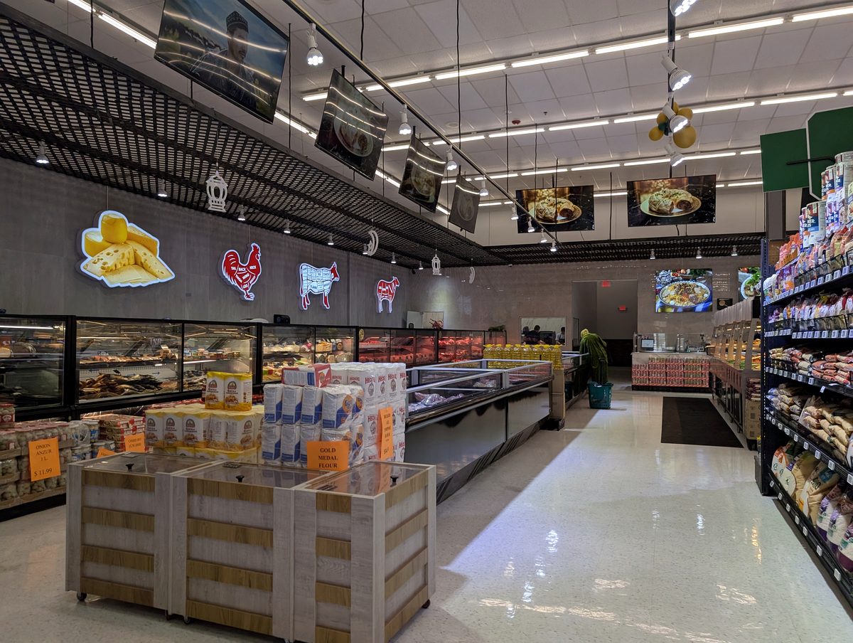 Refrigerated meat and seafood counters along the aisle at ASR Food Market.
